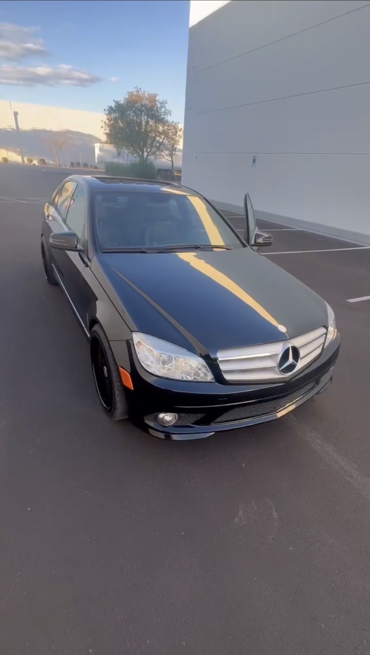Glossy black Mercedes-Benz C-Class detailed in a parking lot